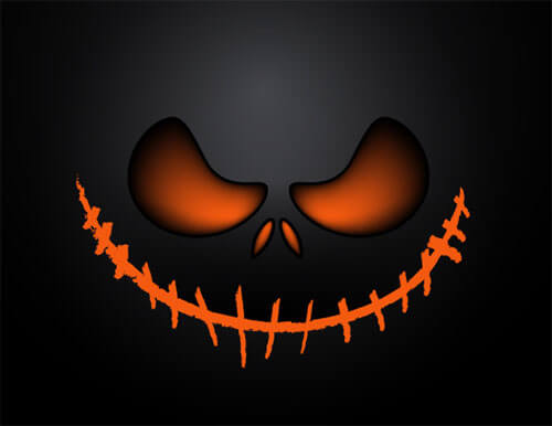 The face of a pumpkin in front of a black background