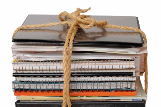 Stack of notebooks and binders with words ‘semester end’ written above it.