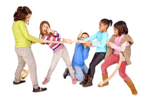 Group of young kids playing tug of war