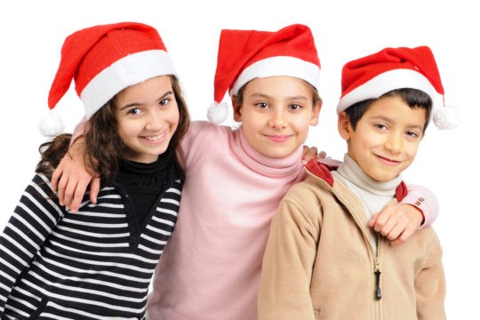 A group of smiling students posing together wearing Santa hats