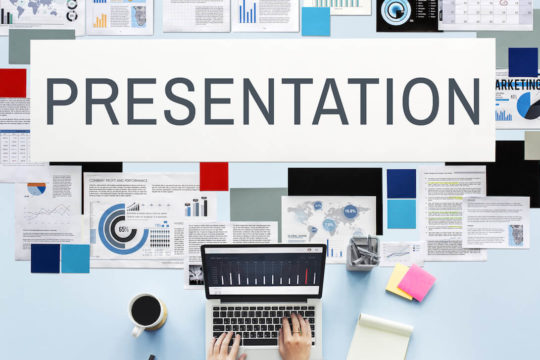 The word ‘presentation’ surrounded by types of presentations and someone typing on a laptop.