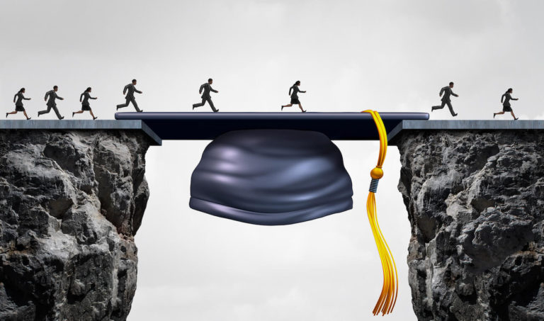 A graduation cap bridging the gap between two cliffs with people running across.
