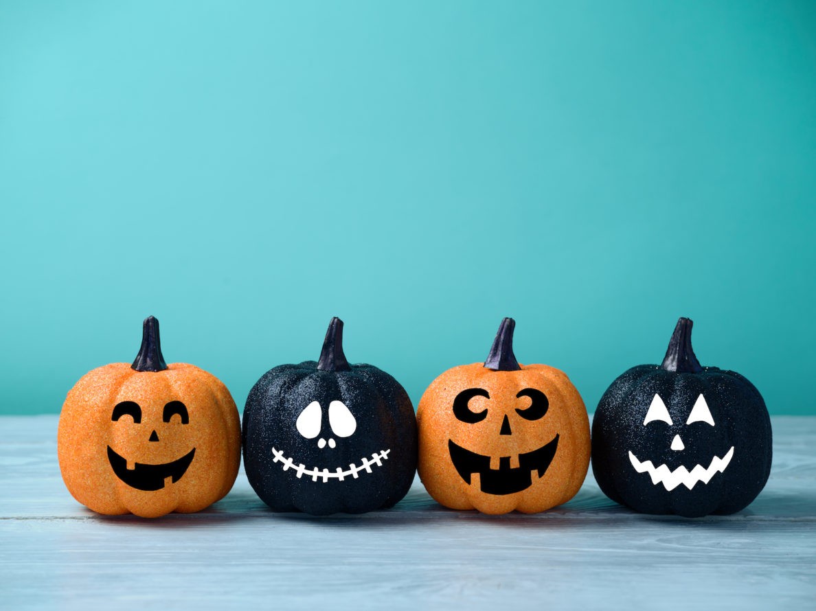 A line of Halloween pumpkins with funny faces