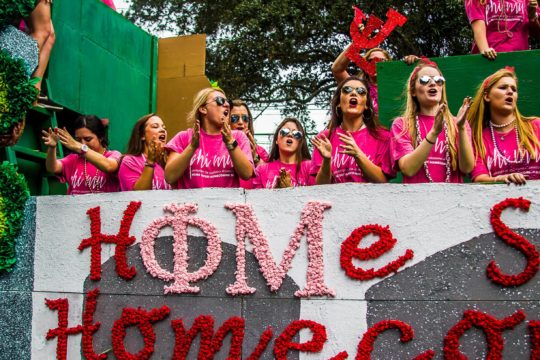 A group of female students standing on a homecoming float