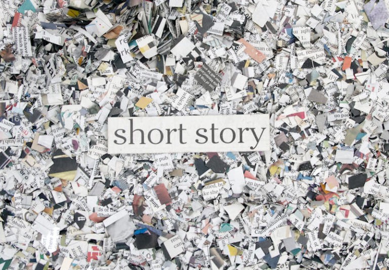 Book confetti shown from above with the text “short story” written over it.