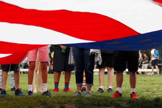 Students work together to fold a giant American flag.